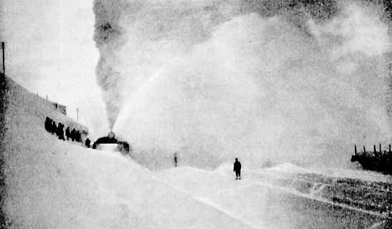 Steam powered snow thrower in action 